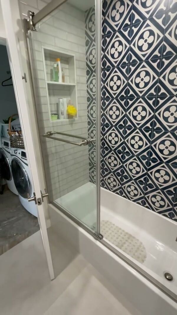 Tub in Pasadena with blue and white patterned tile and a sliding glass door